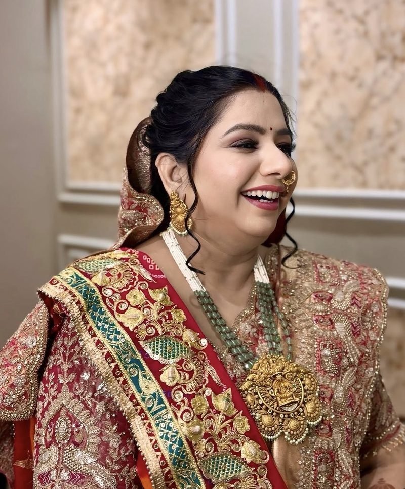 Bridal makeup by Priya Gupta, bride in a red and green saree
